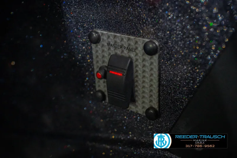 Slide: The Image of Master panel switch on 2016 Bass Cat Cougar boat, textured background, Reeder Trausch Marine logo. - 36