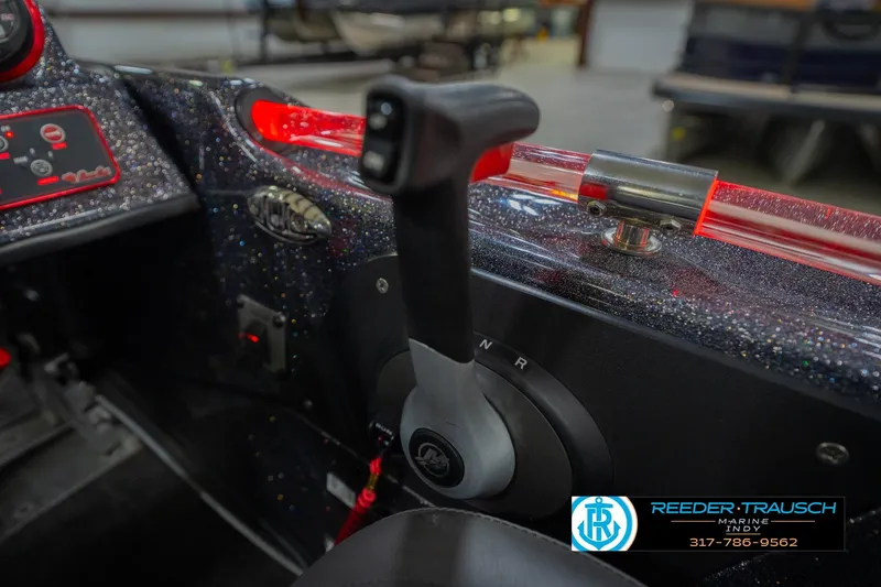 Slide: The Image of 2016 Bass Cat Cougar boat control panel with throttle lever and glittery dashboard. - 37