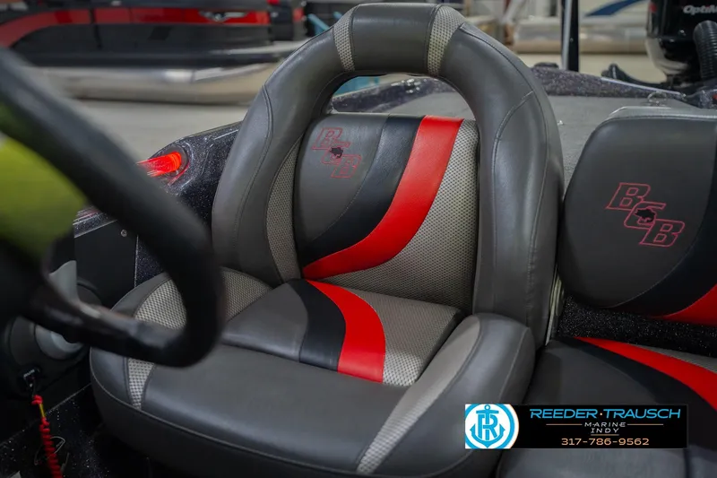 Slide: The Image of 2016 Bass Cat Cougar boat seat with red and gray design, Reeder-Trausch Marine logo visible. - 38