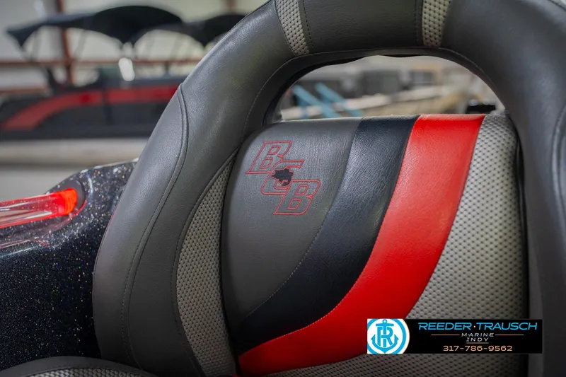 Slide: The Image of 2016 Bass Cat Cougar boat seat with red and black accents, Reeder-Trausch Marine logo. - 39