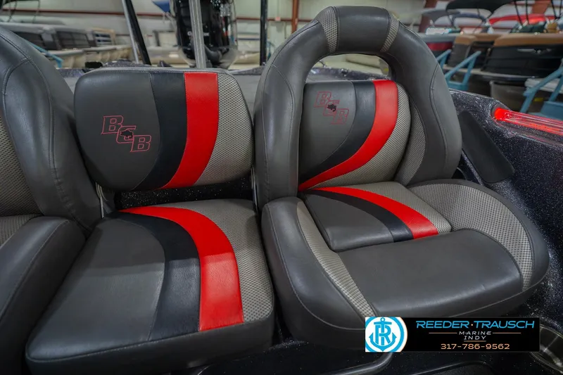 Slide: The Image of 2016 Bass Cat Cougar boat seats with red and black accents in showroom. - 40