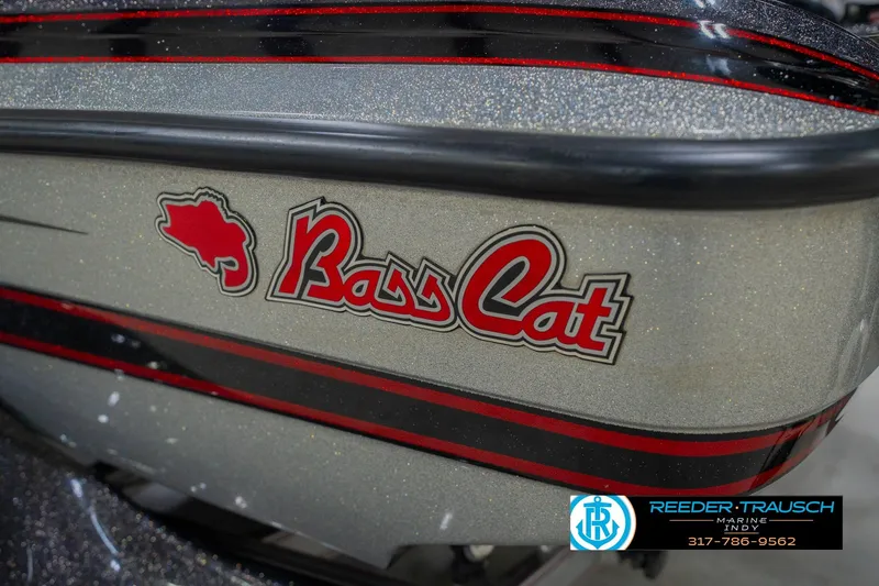 Slide: The Image of 2016 Bass Cat Cougar boat with red and black detailing, Reeder Trausch Marine logo visible. - 58