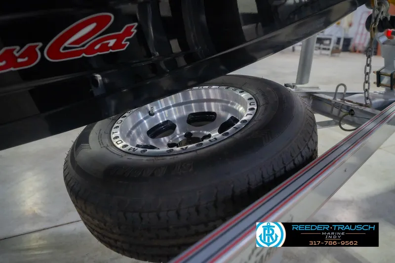 Slide: The Image of 2016 Bass Cat Cougar trailer tire with chrome rim, displayed at Reeder Trausch Marine. - 61
