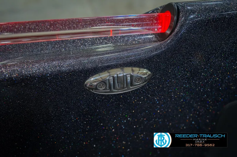 Slide: The Image of 2016 Bass Cat Cougar boat detail with metallic finish and red light. - 62