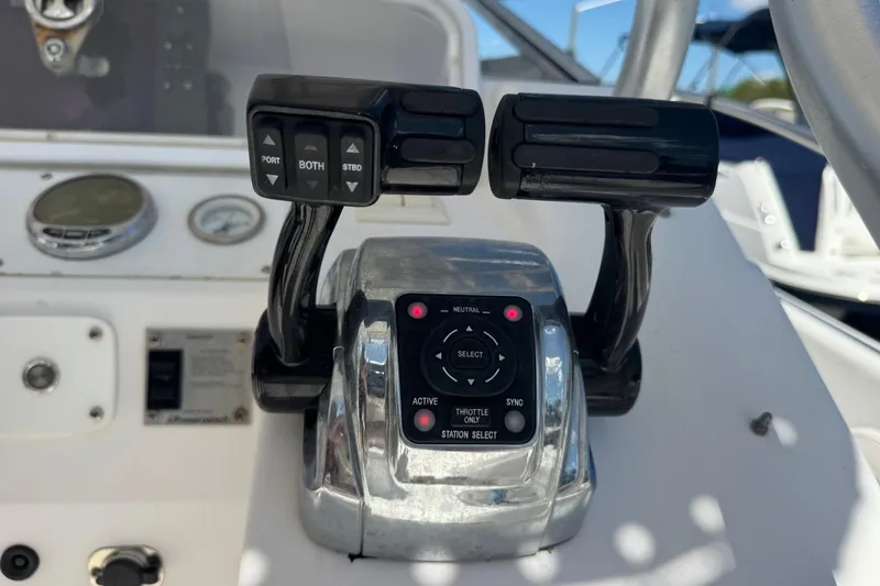 Slide: The Image of Throttle controls on a 2001 Pro-Line 30 Express boat dashboard. - 14