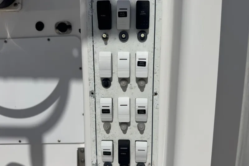 Slide: The Image of Control panel of a 2001 Pro-Line 30 Express boat with labeled switches. - 15