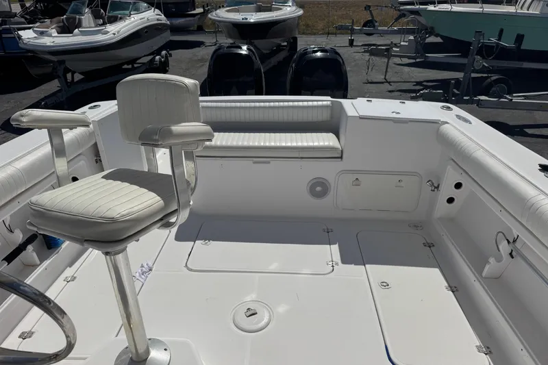 Slide: The Image of 2001 Pro-Line 30 Express boat interior with white seating and storage compartments. - 18