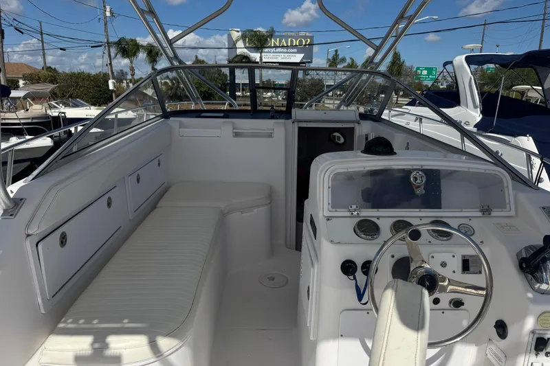 Slide: The Image of 2001 Pro-Line 30 Express boat interior with steering wheel and seating under clear blue sky. - 19