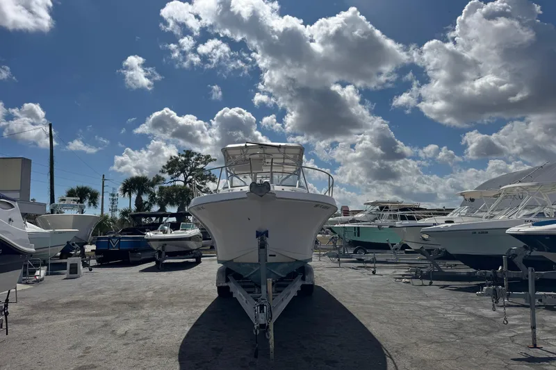 Slide: The Image of 2001 Pro-Line 30 Express boat on trailer under a partly cloudy sky. - 2