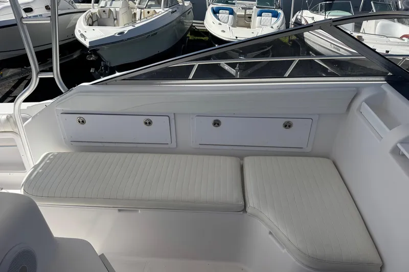 Slide: The Image of 2001 Pro-Line 30 Express boat interior with white seating and storage compartments. - 20
