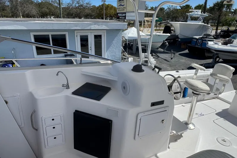 Slide: The Image of 2001 Pro-Line 30 Express boat interior with helm, seating, and sink area. - 23