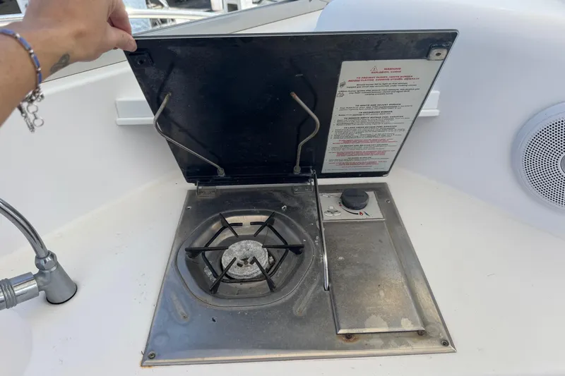 Slide: The Image of Boat stove on 2001 Pro-Line 30 Express, with open lid and visible burner. - 24