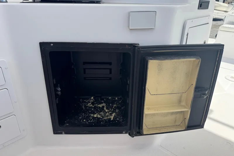 Slide: The Image of Open storage compartment on 2001 Pro-Line 30 Express boat. - 26