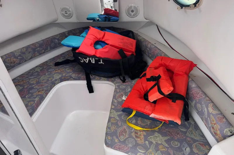 Slide: The Image of Interior of 2001 Pro-Line 30 Express boat with life jackets on patterned seating. - 27