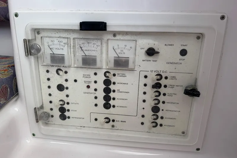 Slide: The Image of Electrical control panel on a 2001 Pro-Line 30 Express boat, featuring AC and DC gauges. - 28