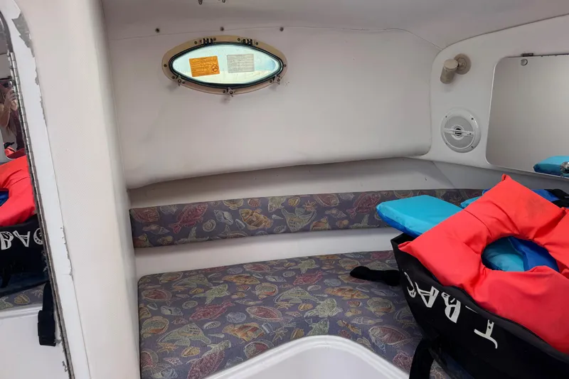 Slide: The Image of 2001 Pro-Line 30 Express cabin interior with patterned seating and life jackets. - 29