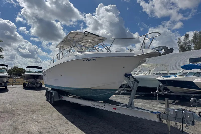 Slide: The Image of 2001 Pro-Line 30 Express boat on trailer under cloudy sky. - 3