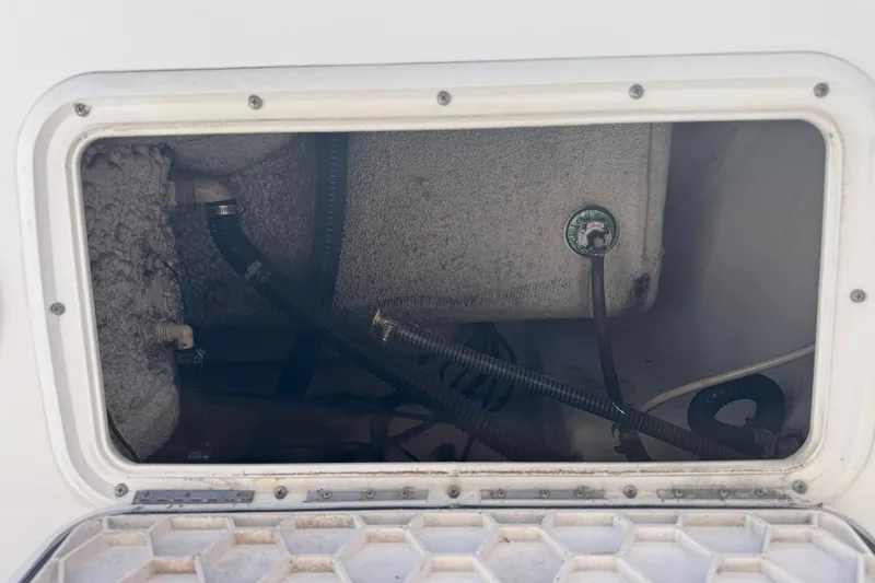 Slide: The Image of 2001 Pro-Line 30 Express boat compartment with visible hoses and fittings. - 41