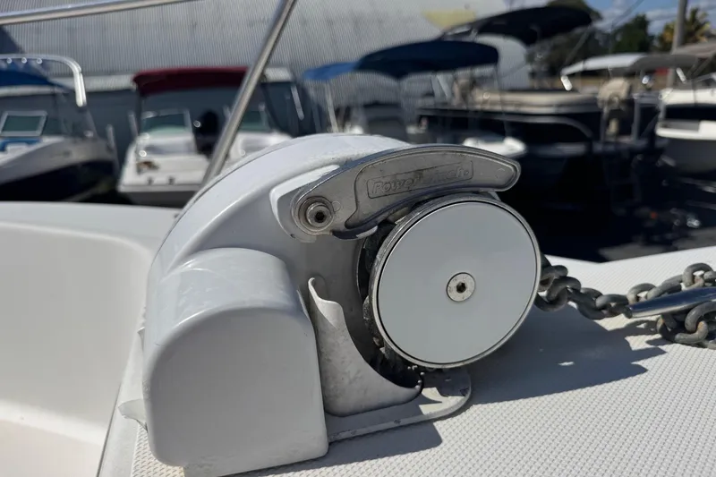 Slide: The Image of Anchor windlass on 2001 Pro-Line 30 Express boat, docked with other vessels. - 43