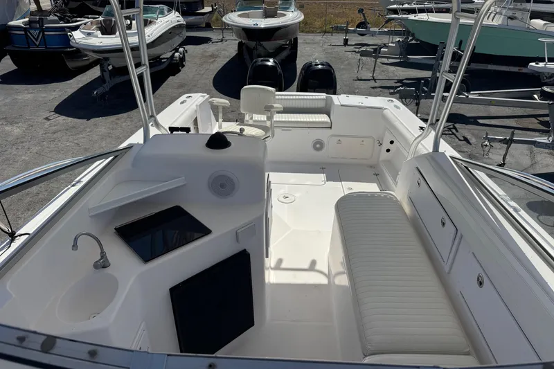 Slide: The Image of 2001 Pro-Line 30 Express boat interior with seating and sink, docked among other boats. - 45