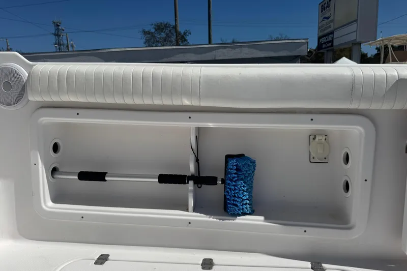 Slide: The Image of Storage compartment on a 2001 Pro-Line 30 Express boat with cleaning tools. - 46