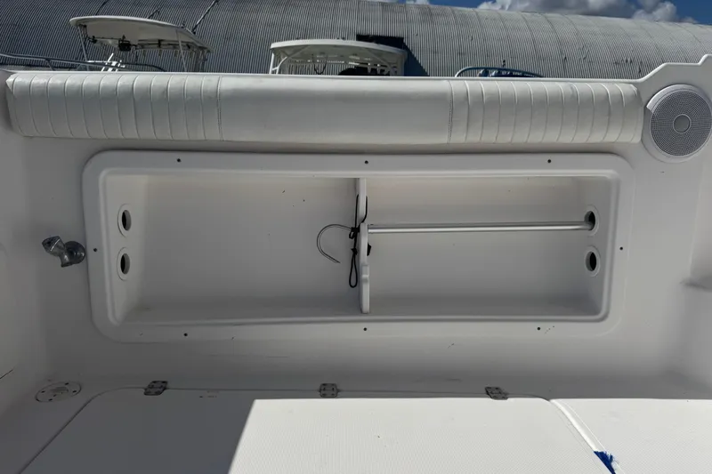 Slide: The Image of 2001 Pro-Line 30 Express boat storage compartment with padded seating and speaker. - 47