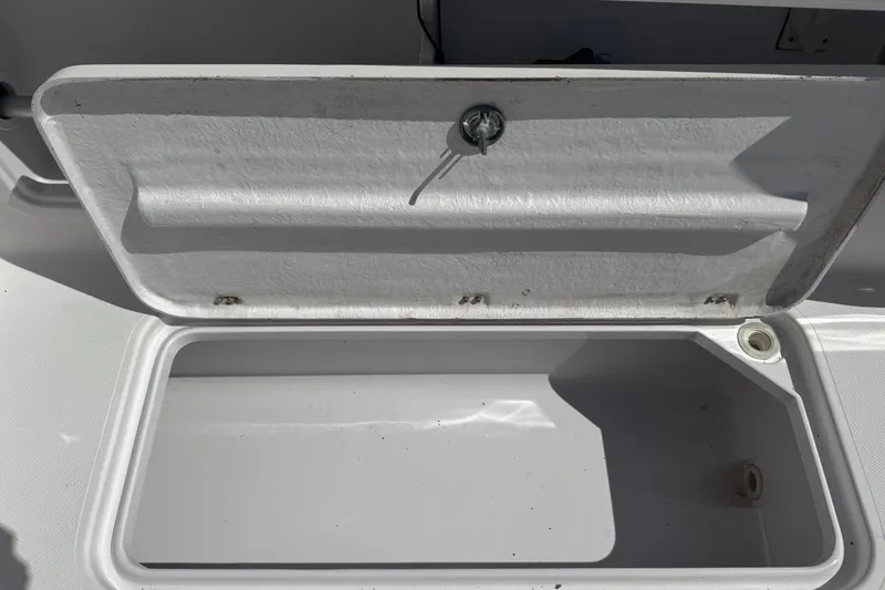 Slide: The Image of Open storage compartment on a 2001 Pro-Line 30 Express boat. - 49