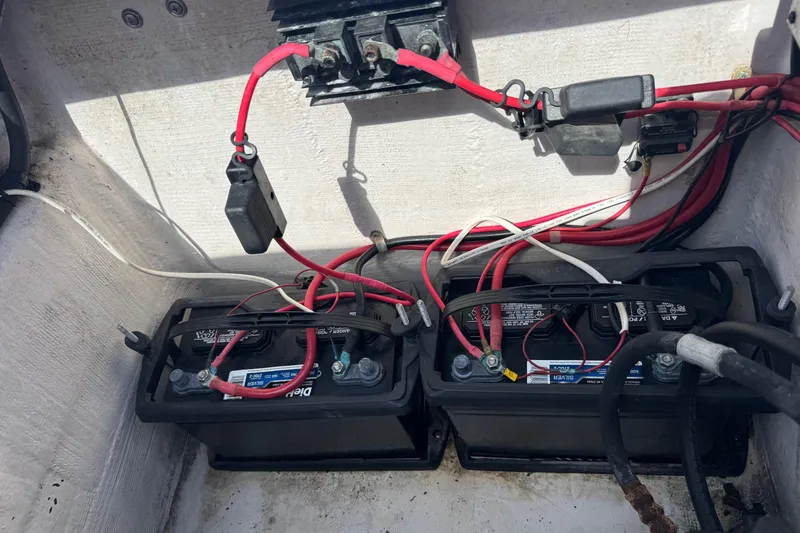 Slide: The Image of 2001 Pro-Line 30 Express boat battery compartment with wiring and connections. - 54