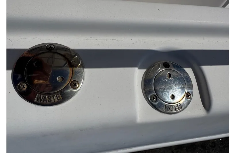 Slide: The Image of 2001 Pro-Line 30 Express boat waste and water fill ports. - 56