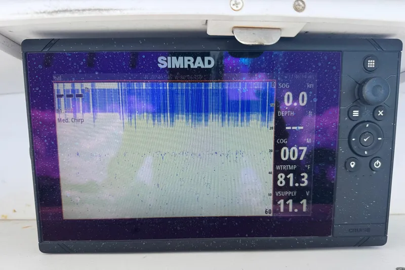 Slide: The Image of Simrad marine display on 2001 Pro-Line 30 Express boat, showing sonar and navigation data. - 7