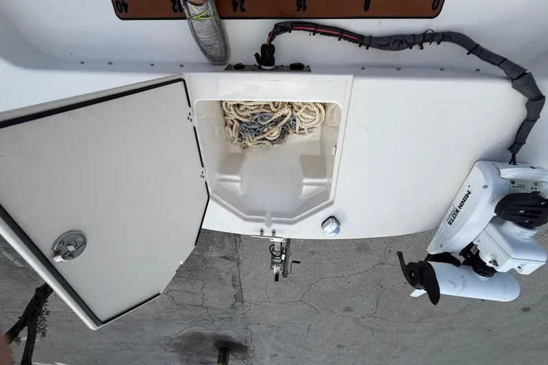 Slide: The Image of 2023 Carolina Skiff 21 LS boat deck with storage compartment and trolling motor. - 15