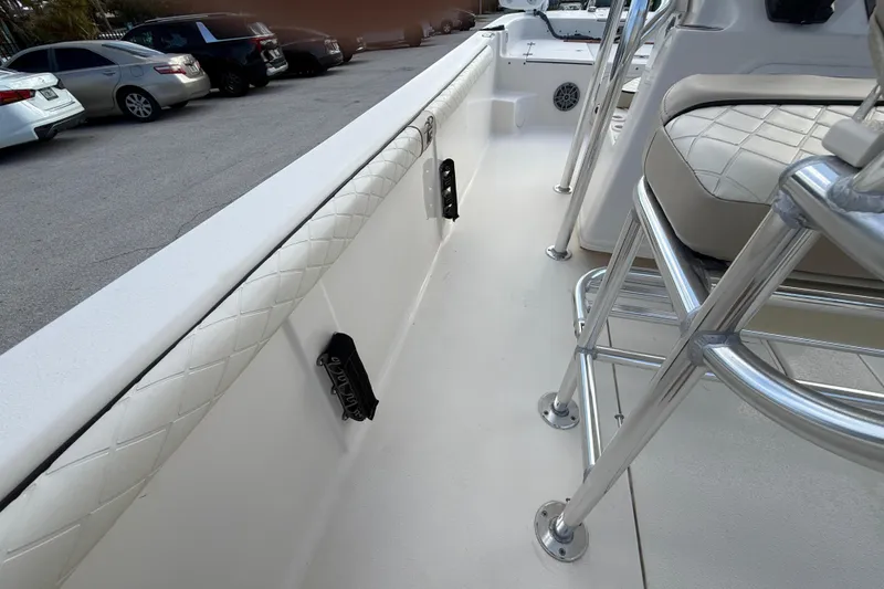 Slide: The Image of 2023 Carolina Skiff 21 LS boat interior with cushioned seating and metal framework. - 18