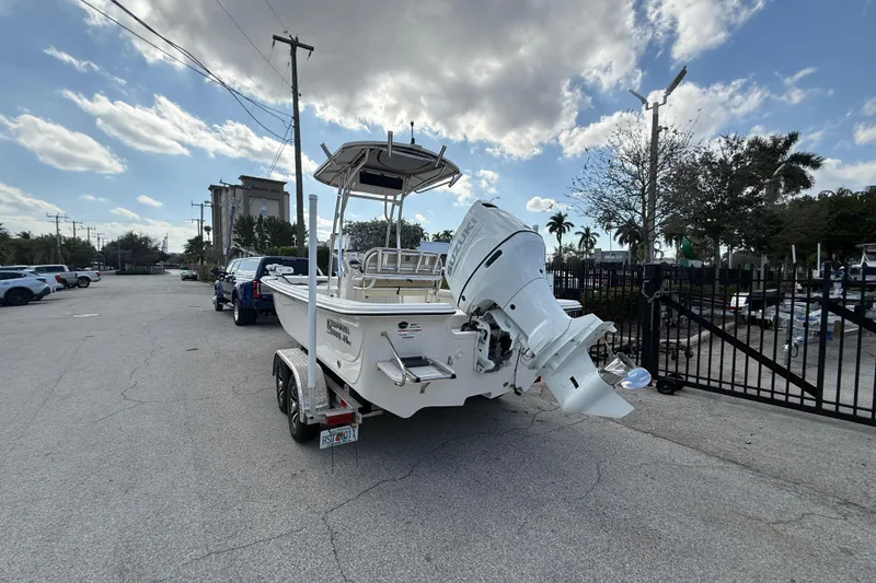 Slide: The Image of 2023 Carolina Skiff 21 LS boat on trailer, parked outdoors under a cloudy sky. - 4