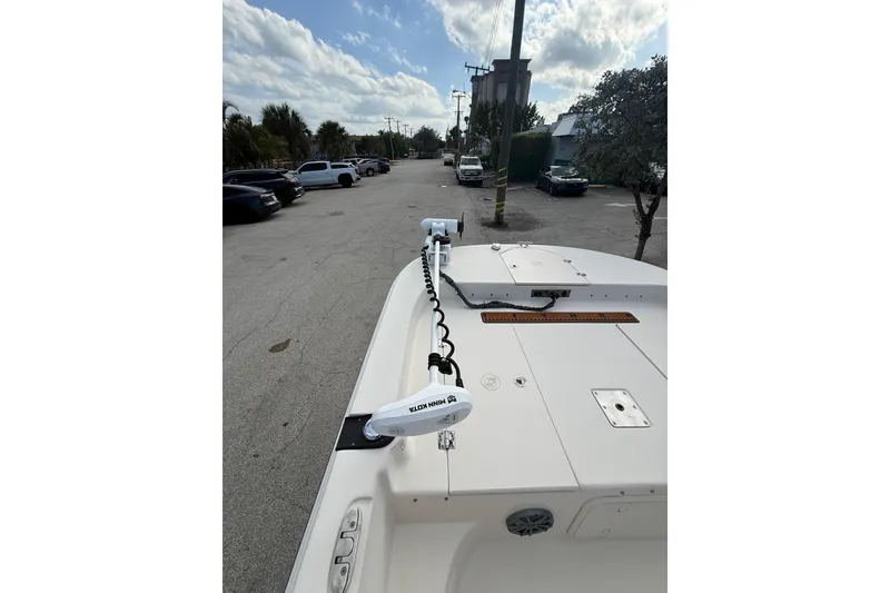 Slide: The Image of 2023 Carolina Skiff 21 LS boat with Minn Kota trolling motor in a parking lot. - 9