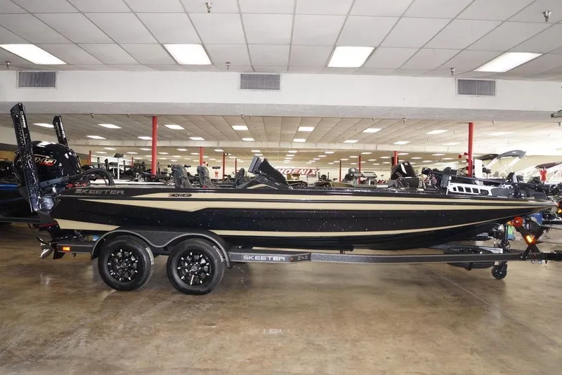 The Image of 2026 Skeeter ZXE21 boat displayed in showroom, featuring sleek design and dual-axle trailer. - 0