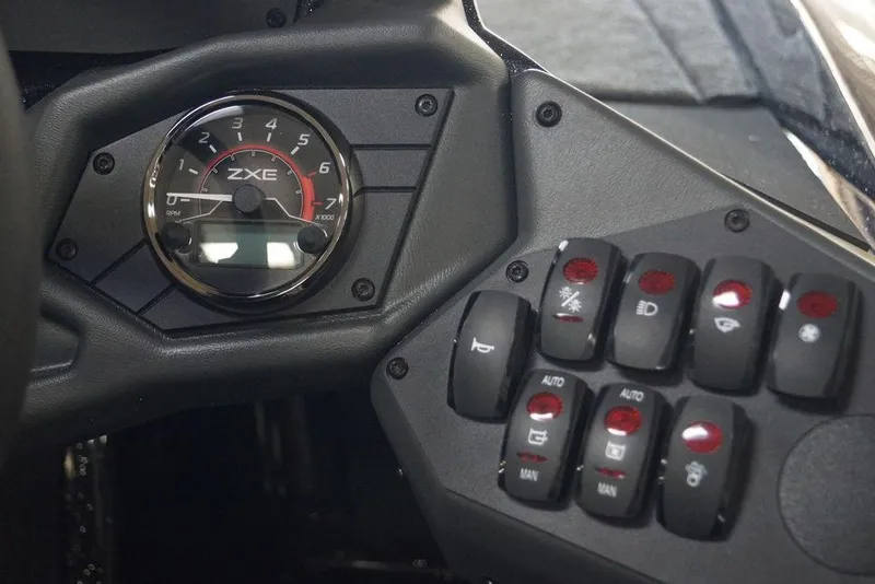Slide: The Image of Dashboard of 2026 Skeeter ZXE21 with tachometer and control switches. - 10