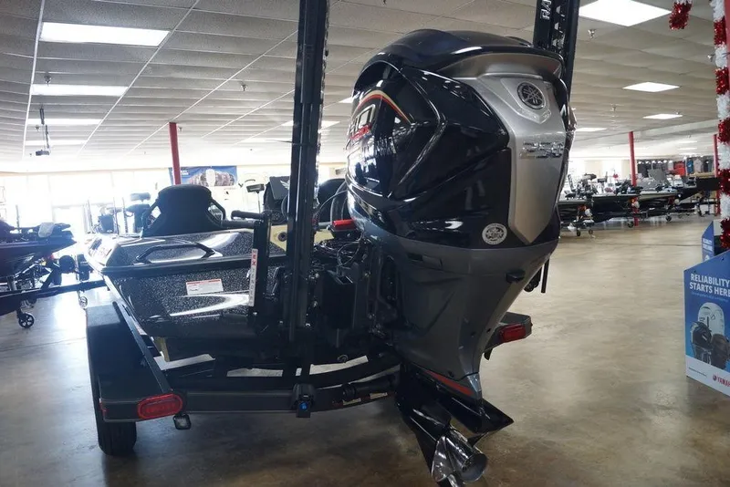 Slide: The Image of 2026 Skeeter ZXE21 boat with powerful outboard motor in showroom setting. - 26