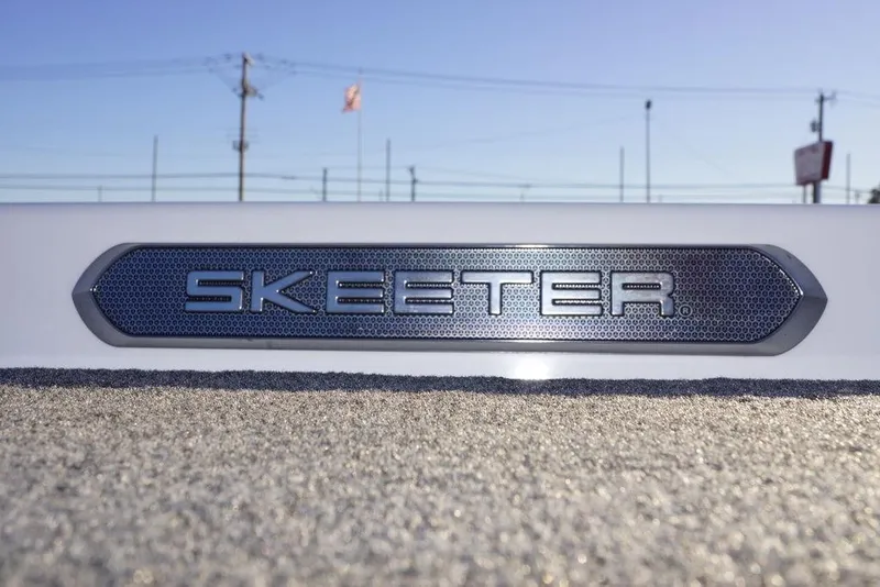 Slide: The Image of 2024 Skeeter FXR21 Limited logo on textured surface, outdoor setting. - 12