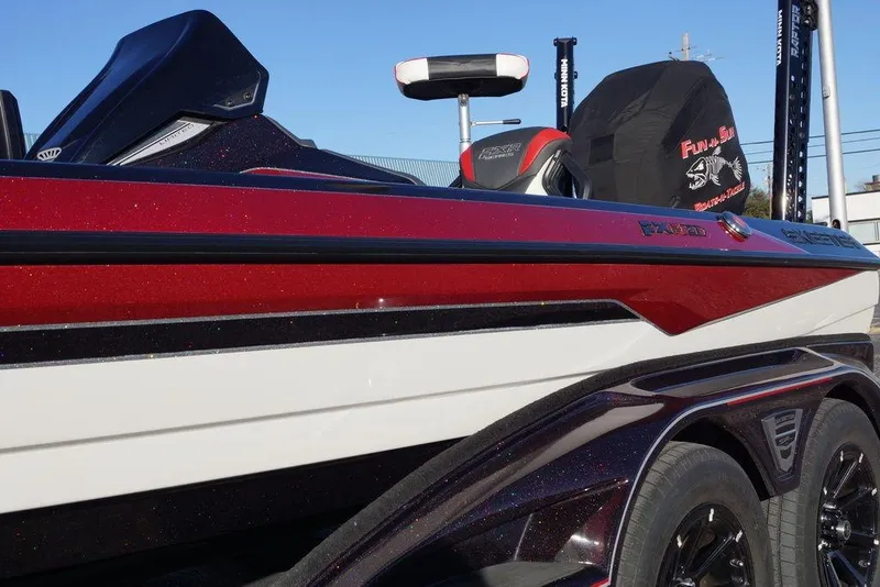 Slide: The Image of 2024 Skeeter FXR21 Limited boat with sleek red and white design, side view. - 19