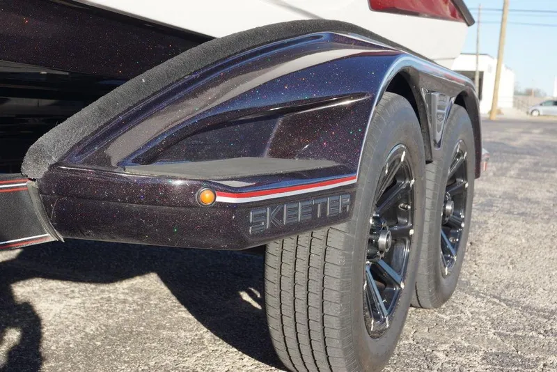 Slide: The Image of 2024 Skeeter FXR21 Limited trailer with dual black wheels and sleek design. - 22