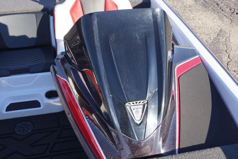 Slide: The Image of 2024 Skeeter FXR21 Limited boat console with sleek black and red design. - 28