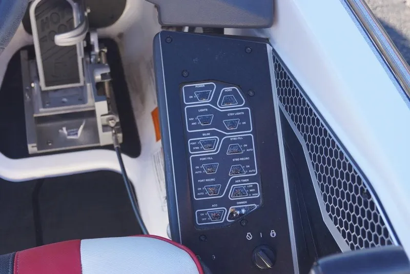 Slide: The Image of 2024 Skeeter FXR21 Limited boat control panel with various switches and buttons. - 31