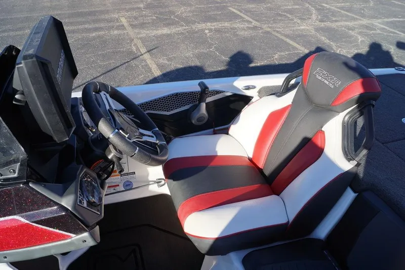Slide: The Image of 2024 Skeeter FXR21 Limited boat interior with steering wheel and red-black seat. - 34