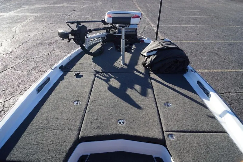 Slide: The Image of 2024 Skeeter FXR21 Limited boat deck with trolling motor and storage compartments. - 9