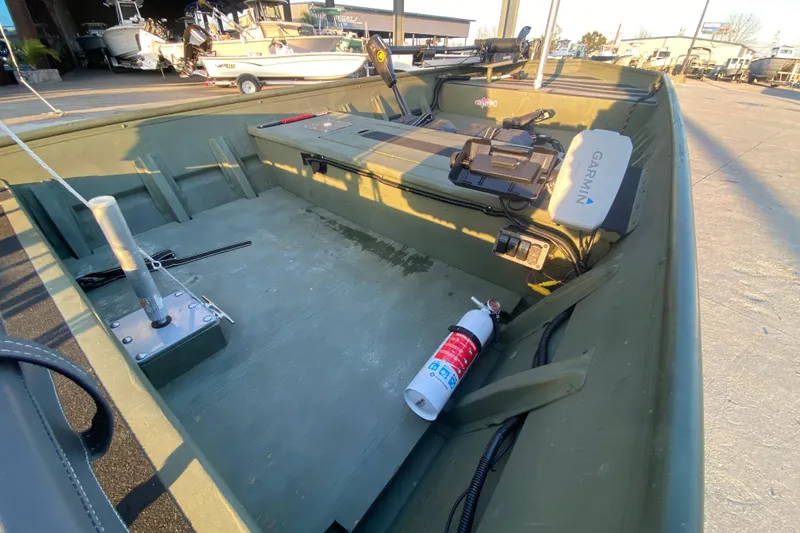 Slide: The Image of 2012 Alumacraft 1448 Jon boat interior with Garmin equipment and fire extinguisher. - 10