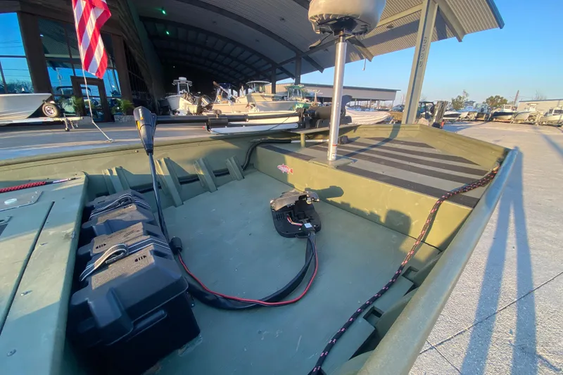 Slide: The Image of 2012 Alumacraft 1448 Jon boat interior with equipment and American flag in background. - 11