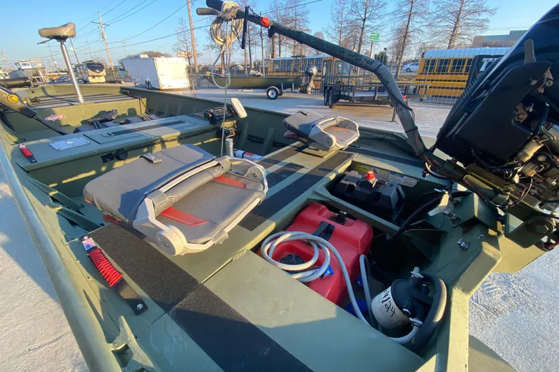 Slide: The Image of 2012 Alumacraft 1448 Jon boat interior with seats, motor, and equipment. - 12