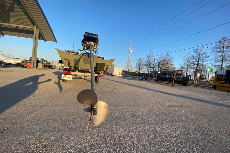 Slide: The Image of 2012 Alumacraft 1448 Jon boat with motor, parked outdoors on a sunny day. - 4