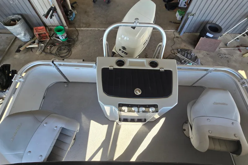 Slide: The Image of 2017 SilverWave 230 Island boat interior with seating and control panel, viewed from above. - 13