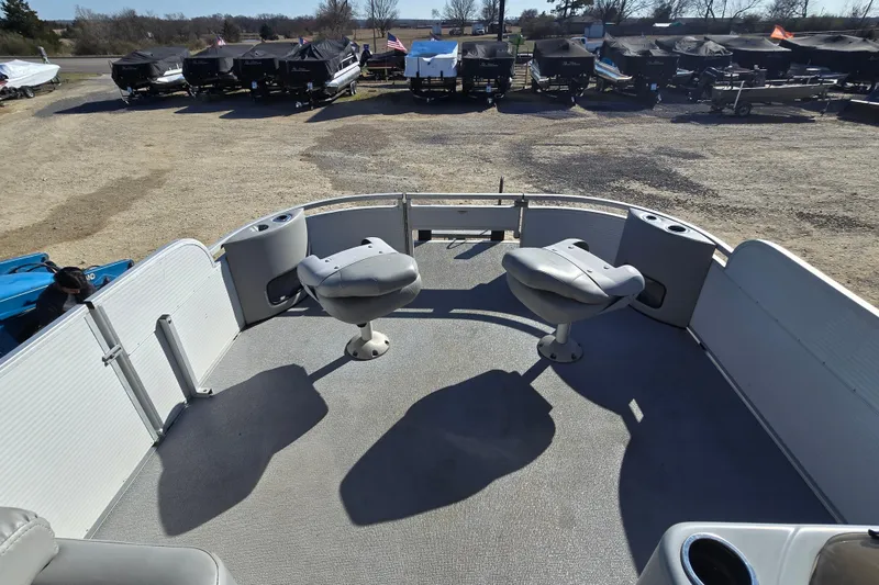 Slide: The Image of 2017 SilverWave 230 Island boat deck with two swivel seats, parked outdoors. - 14